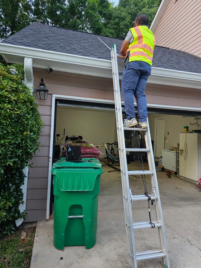 Solar installer using ladder to survey roof