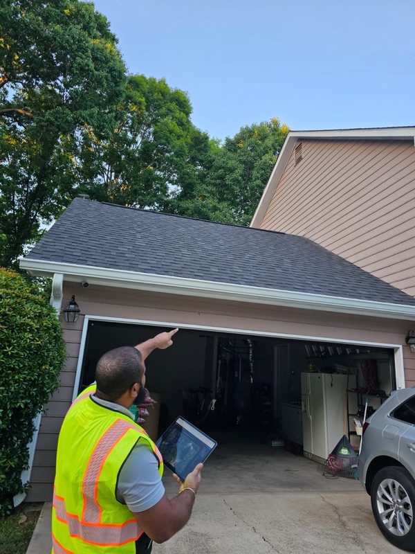 Surveyor identifying solar panel locations on roof